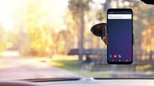 Over the dashboard of a car, TRUCE distracted driving software protects a driver.