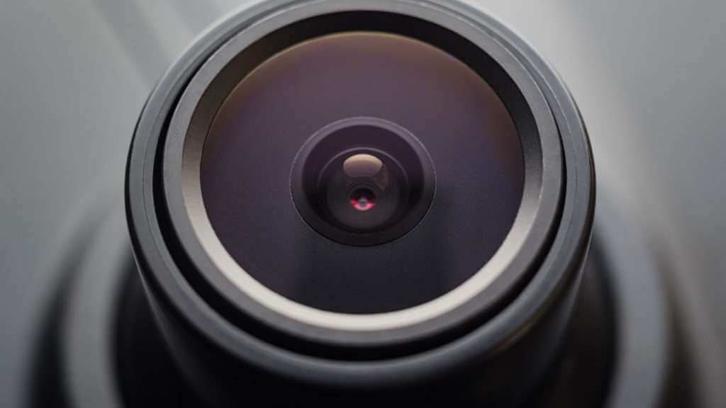 Close up of a dash camera lens inside a vehicle