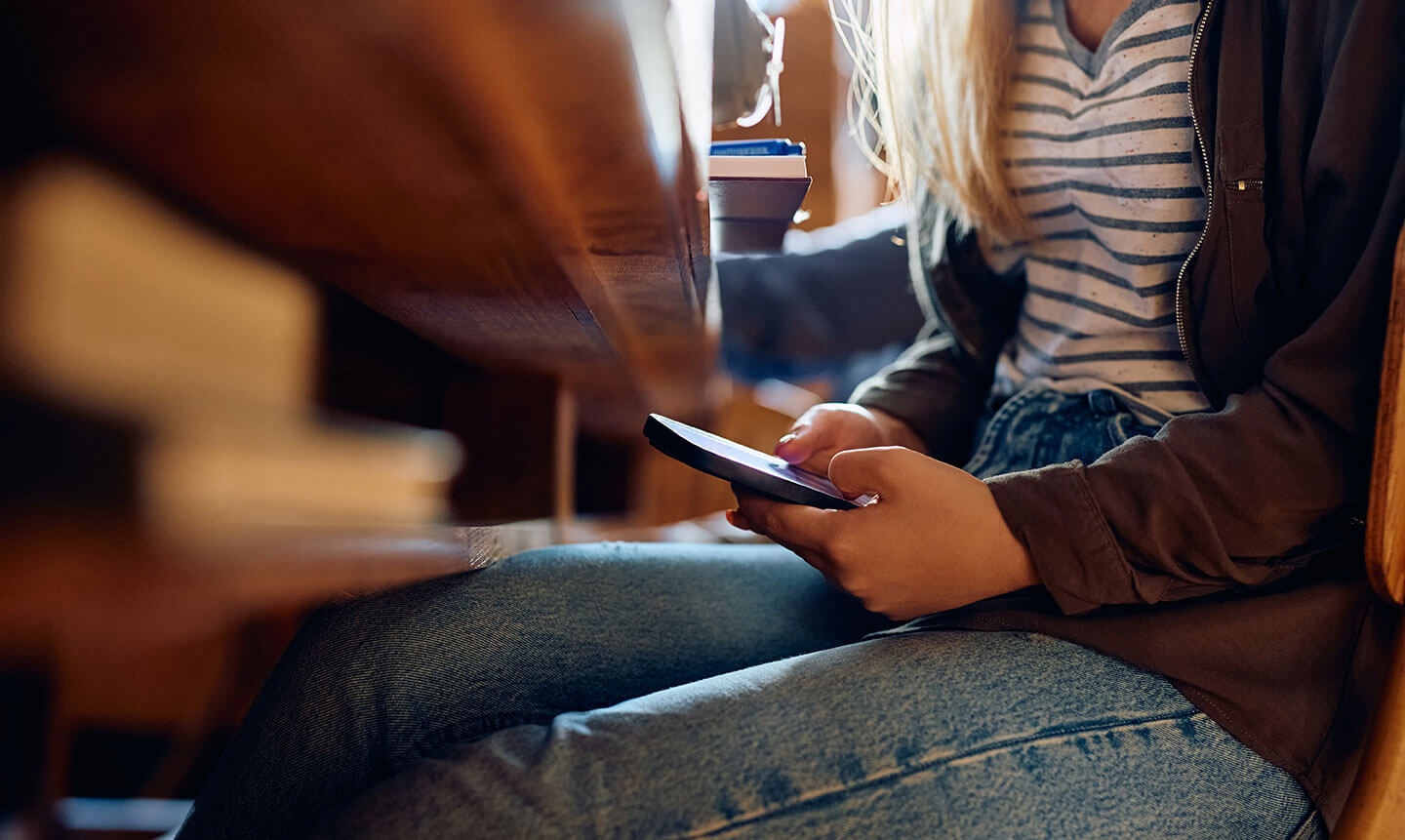 student-texting-on-mobile-phone-during-school